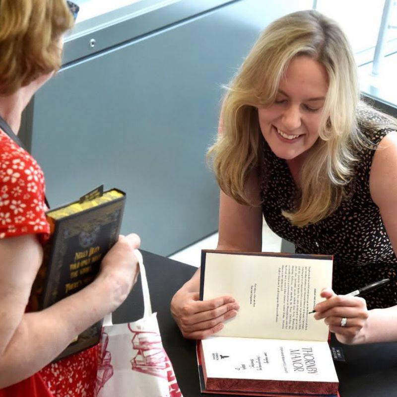 11 People in the queue for a book signing at the Palace Theatre in Newark. They are all holding up a copy of The Strawberry Thief by Joanne Harris.